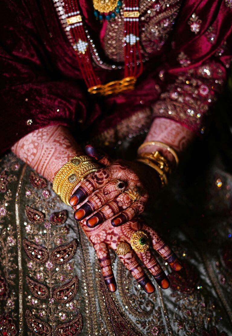 Elegantly adorned hands with detailed henna and traditional jewelry, reflecting cultural richness.